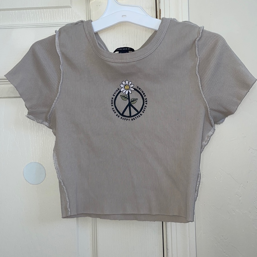 cropped tan t-shirt with words. “smile more and be happy…”